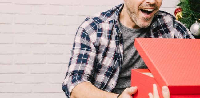 homem a abrir presente de natal